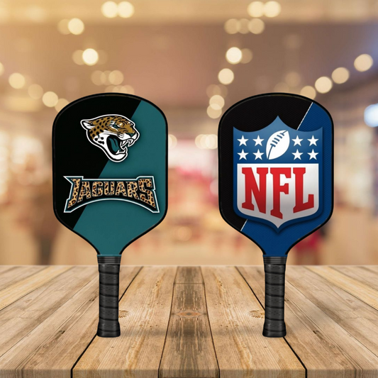 Two pickleball paddles with Jaguars and NFL logos on a wooden surface.