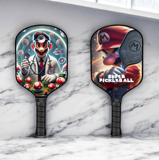 Two pickleball paddles with Mario and Dr. Mario designs on a marble surface