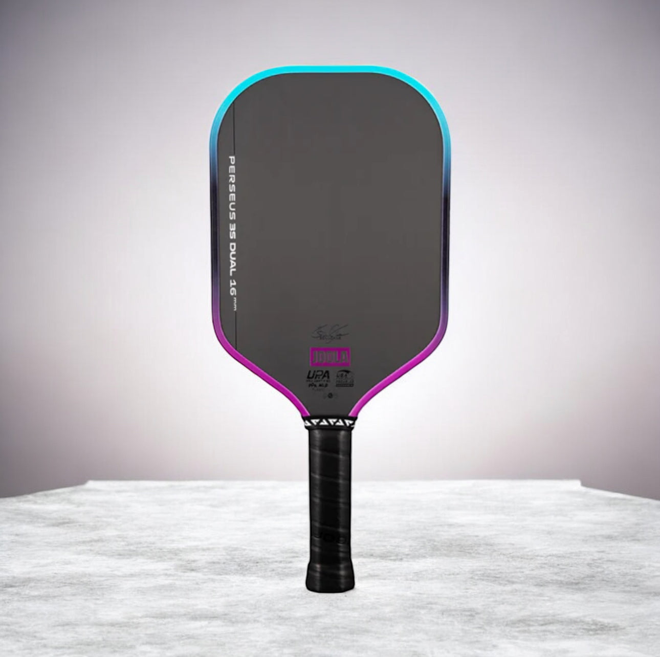 Pickleball paddle with black and purple design on a gray background