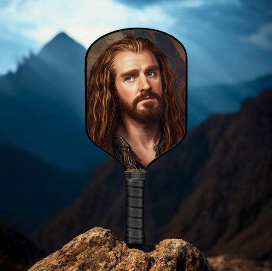Man with long hair and beard in a mirror against a mountainous background