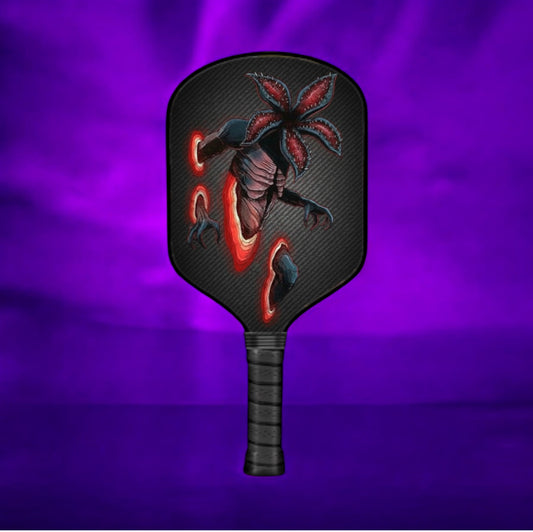 Pickleball paddle with a dragon design on a purple background