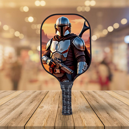 Pickleball paddle with character design on a wooden surface