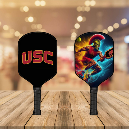 Two pickleball paddles on a wooden surface with a blurred background