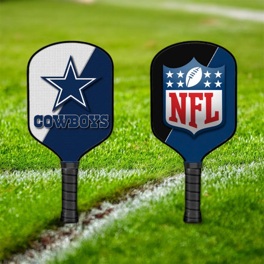 Two pickleball paddles with Dallas Cowboys and NFL logos on a grass field.