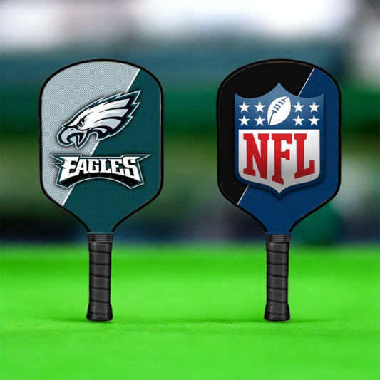 Two pickleball paddles with Eagles and NFL logos on a green background