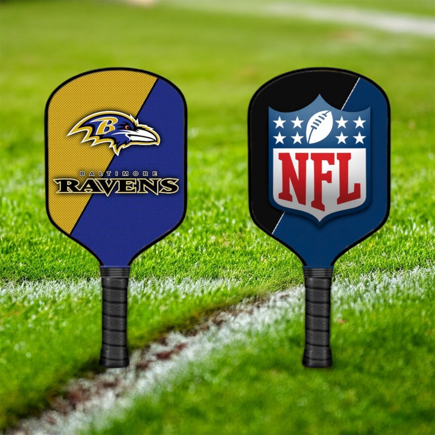 Two pickleball paddles with Baltimore Ravens and NFL logos on a grass field.