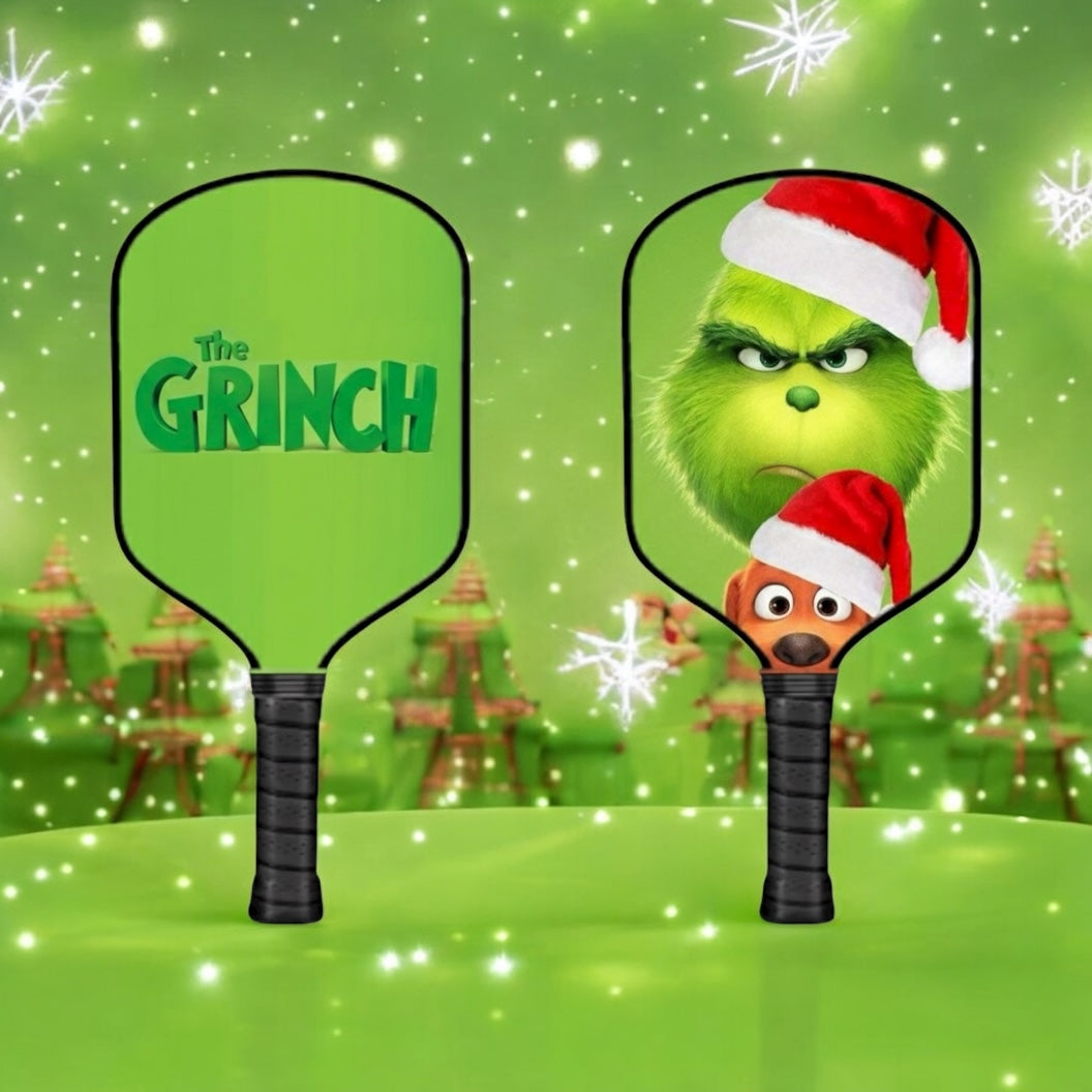Two pickleball paddles with 'The Grinch' design on a festive green background.