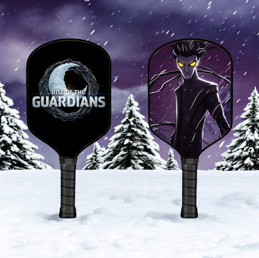 Two pickleball paddles with 'Rise of the Guardians' design against a snowy background