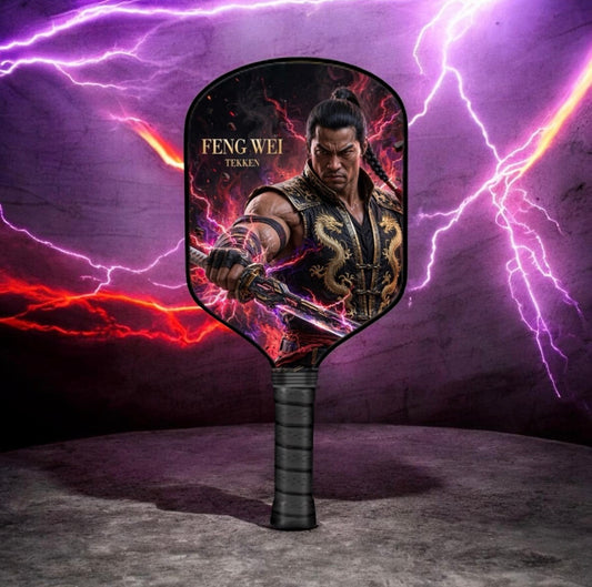 A handheld paddle-style fan with a black handle, featuring artwork of the character Feng Wei from Tekken with purple lightning and red fire effects in the background.