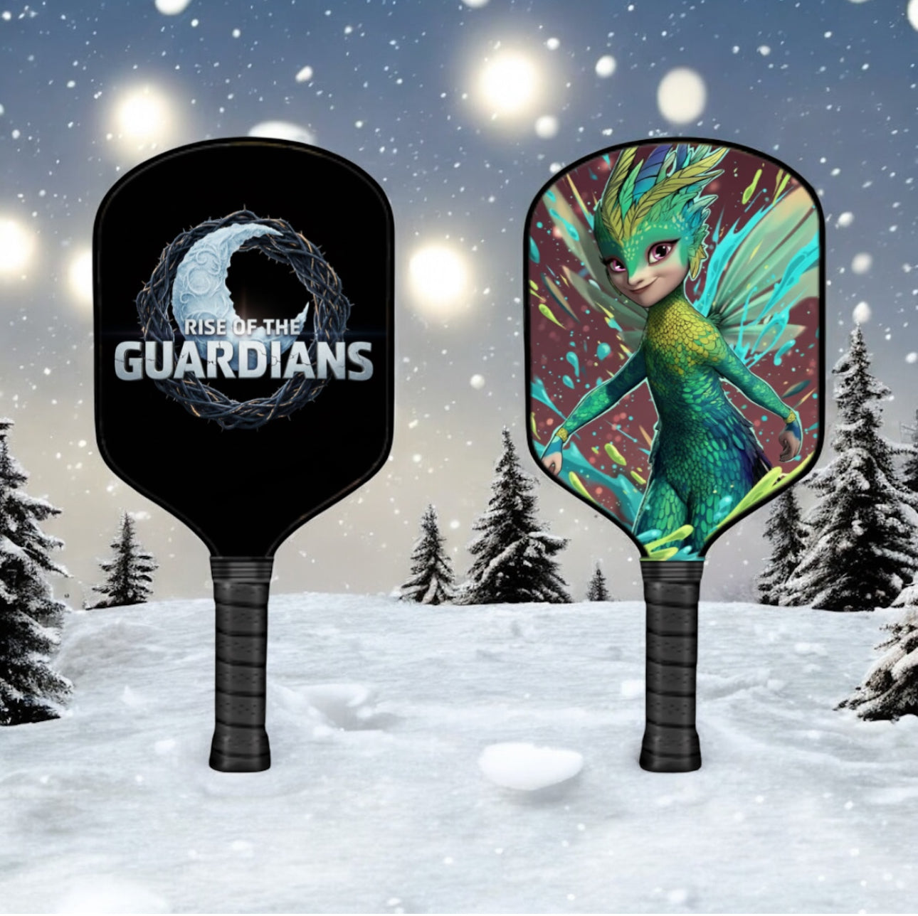 Two pickleball paddles with 'Rise of the Guardians' branding against a snowy background.